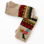 A pair of beige knit fingerless gloves with colorful striped and floral patterns on the cuffs, displayed on a clean white background.